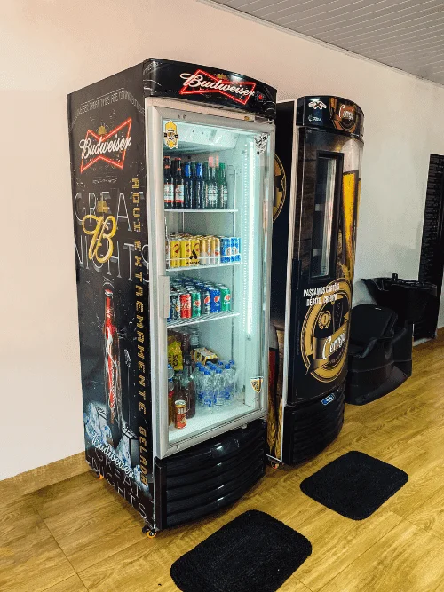 Geladeira com bebidas geladas na Barbearia Santana - cerveja e refrigerante durante o atendimento em Rio Verde